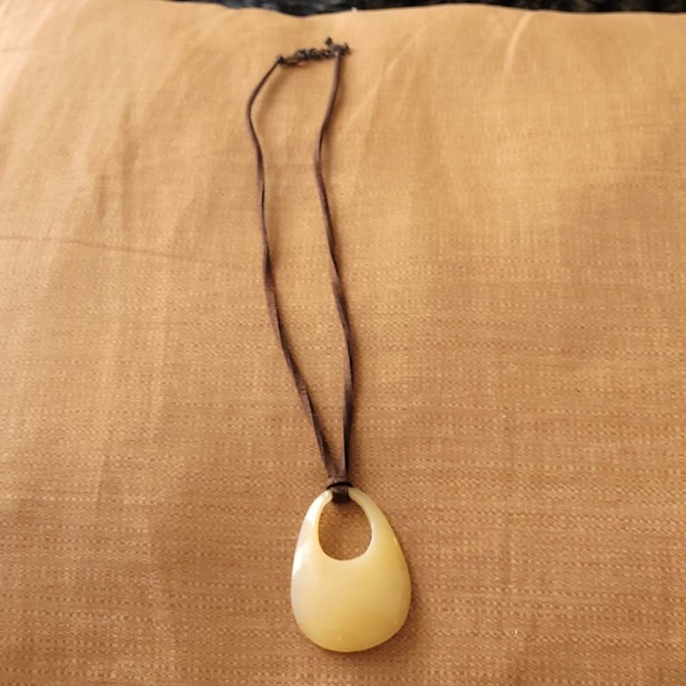 Cream stone pendant with brown suede chain